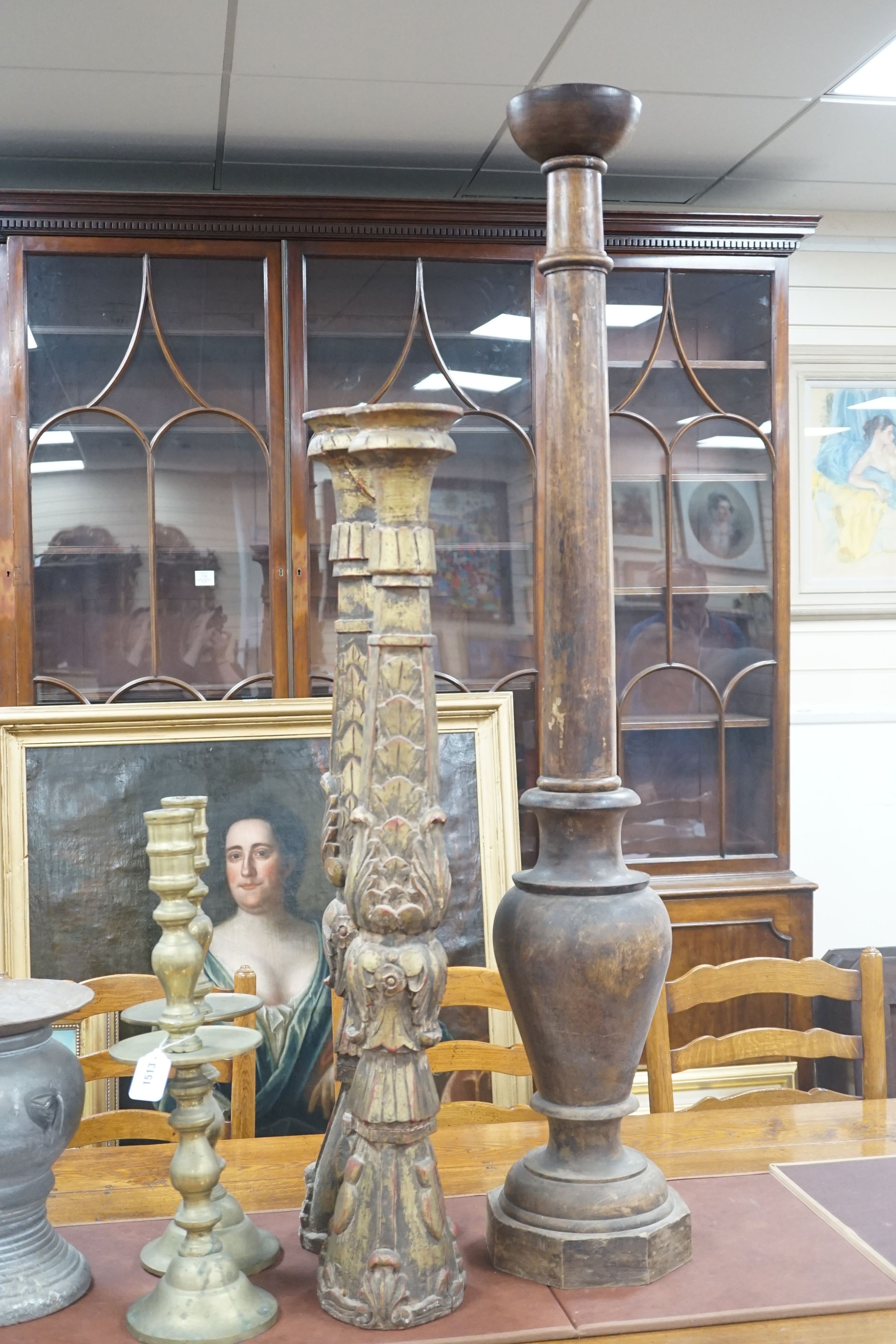 A pair of gilt carved candlesticks, a large turned candlestick, a pair of brass candlesticks and a squat metal candle stick (6), tallest 140cms.